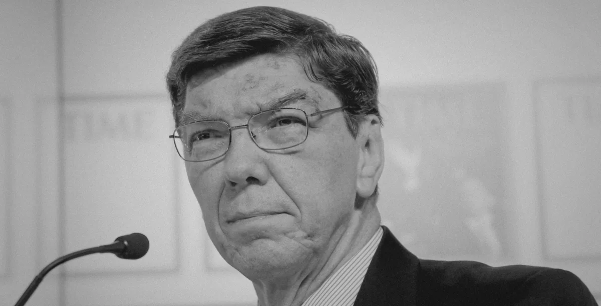 Black & white portrait photo of Clay Christensen in a suite and tie